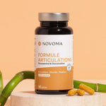 Pilulier de Formule Articulations Novoma avec du bambou sur fond pêche